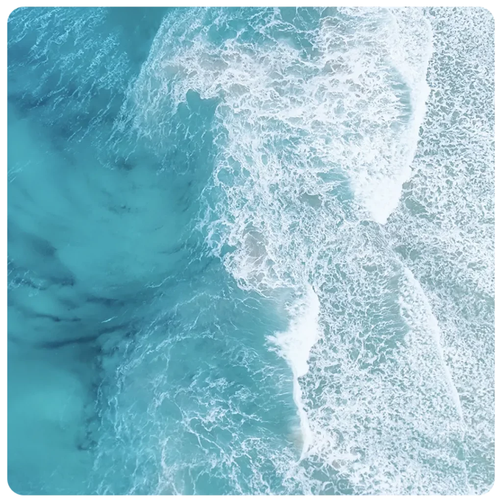 An aerial view of a blue ocean with waves.