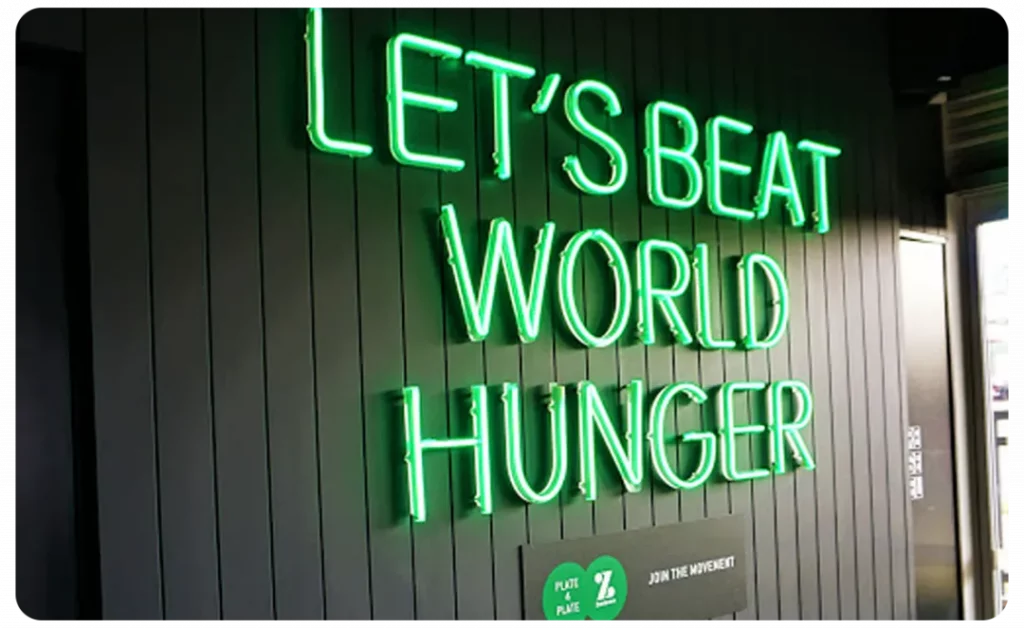 Guzman y Gomez let's beat world hunger neon sign.
