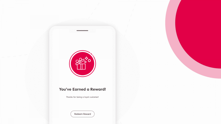 A phone displaying a message that says you've earned a reward, representing a customer loyalty program.