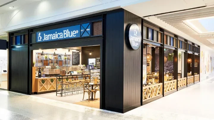 A Jamaica Blue cafe in a shopping mall with tables and chairs.